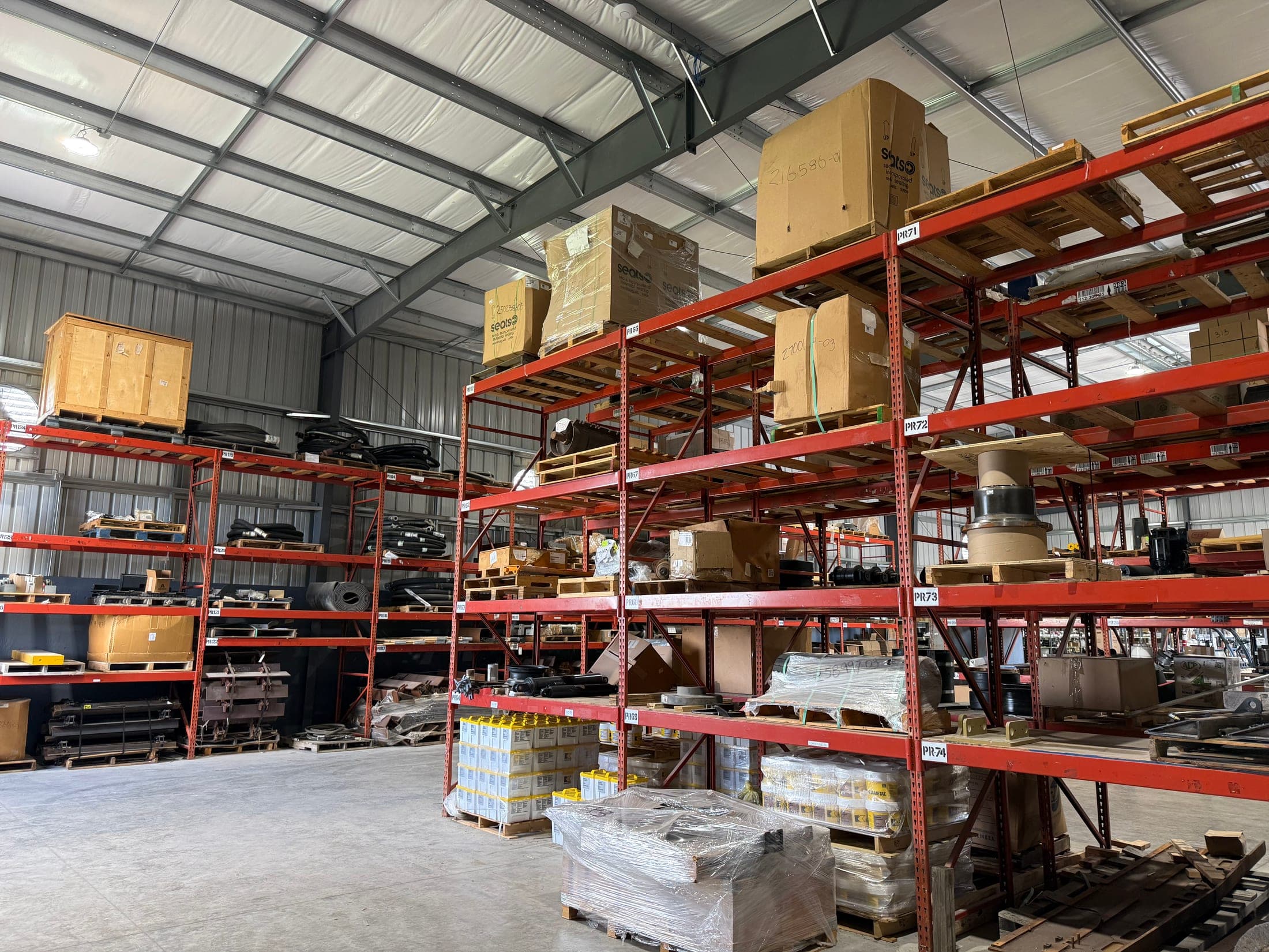 Closner Schertz parts warehouse shelves stocked with equipment parts