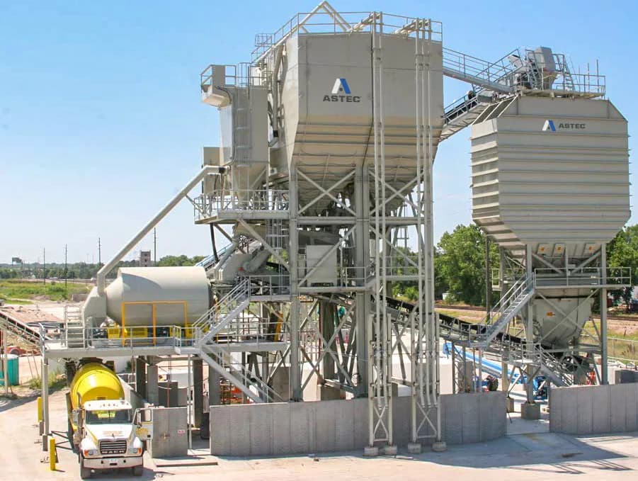 CON-E-CO SLP central mix plant with aggregate bin, cement storage, mixer deck, and ready-mix truck lane