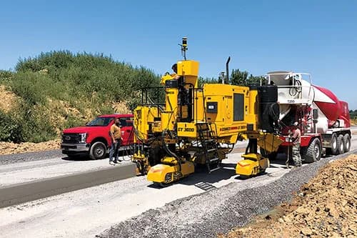 GOMACO GT-3600 slipforming curb and gutter with concrete truck feeding conveyor