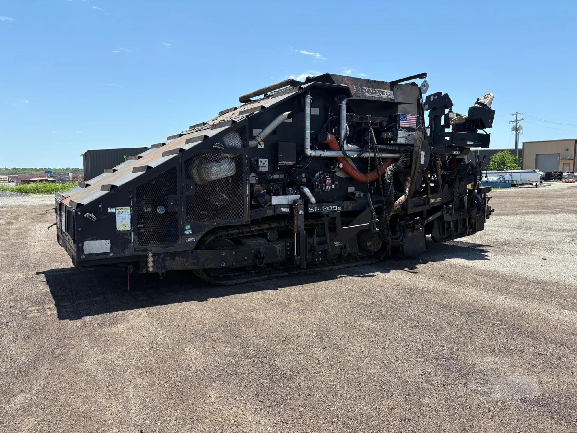 A Roadtec SP200E asphalt paver in good condition, shown from a side angle in a professional listing.
